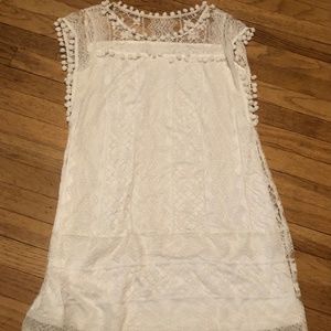 Lacey dress with pom pom detail